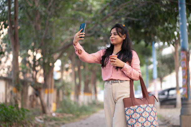 istock Beautiful young woman taking selfie 2198203132