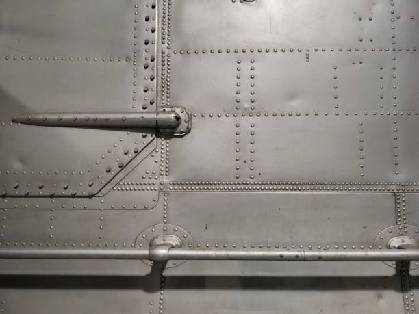 Weathered exterior of a WW2 plane wing with riveted panel lines.