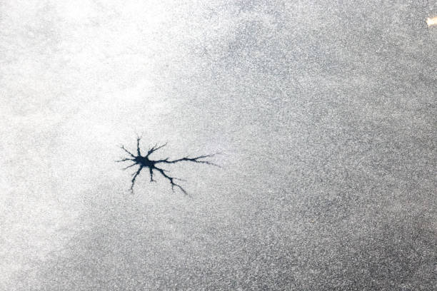 istock Cracked Ice - Craters on Frozen Pond 2198205592