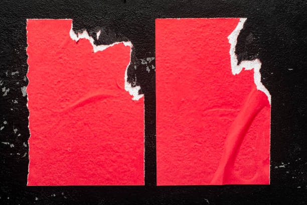 Pieces of torn paper peeling off wall used as billboard