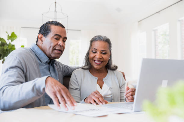 istock Senior Couple Using Laptop, Reviewing Documents Together 2198213487
