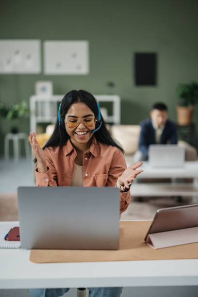 istock Smiling Woman Working from Home with Headset 2198214189