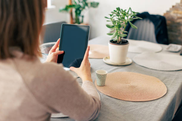 istock Smiling Woman 40-44 Using Tablet at Home 2198214209
