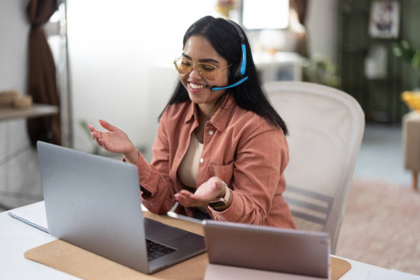 istock Smiling Woman in Casual Office Setting with Tech 2198214532