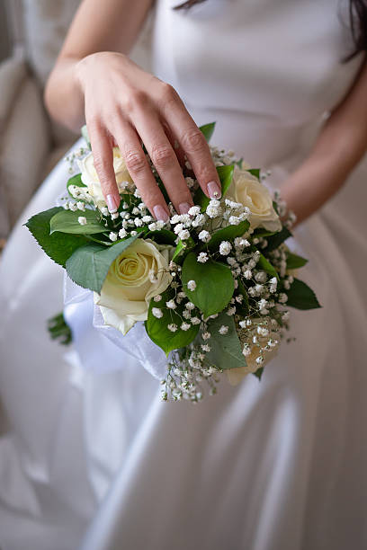 istock bride holds a wedding bouquet in her hands 2198217946