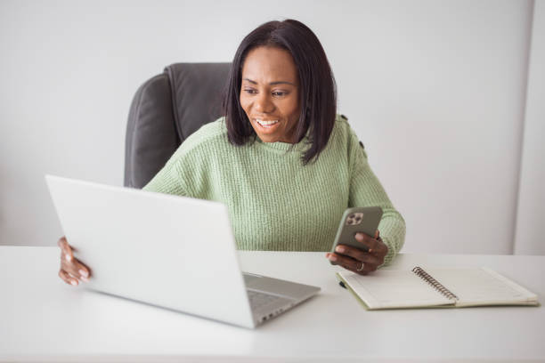 istock Business woman using laptop and smart phone 2198218261