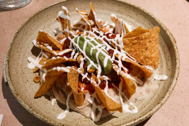 istock Mexican snacks nacho with sour cream and avocado sauce 2198220071