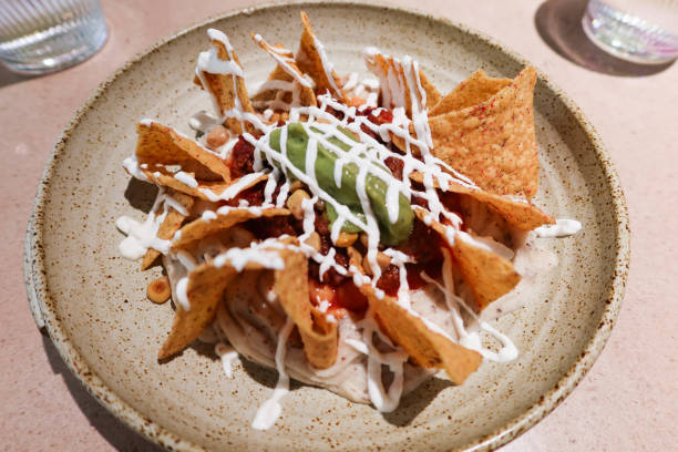 istock Mexican snacks nacho with sour cream and avocado sauce 2198220072
