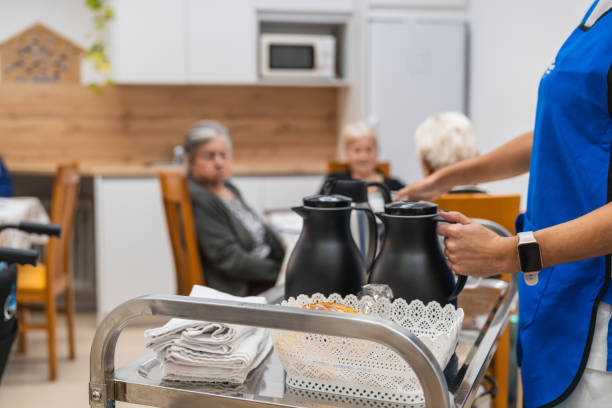 istock Caregiver serving beverages in nursing home 2198220723