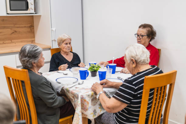 istock Elderly residents enjoying mealtime together 2198221168