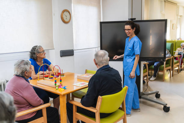 istock Nurse supporting elderly patients during recreational activity in nursing home 2198222027