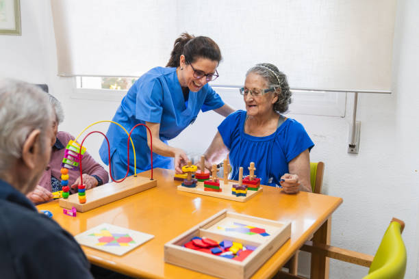 istock Caring nurse assisting seniors with activities 2198222031