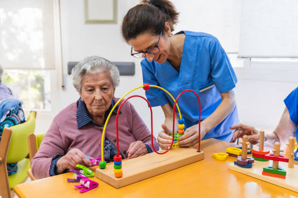 istock Caring nurse assisting elderly woman with therapy 2198222036