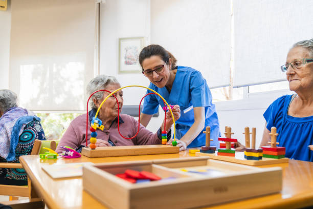 istock Caring nurse assisting seniors with activities 2198222058