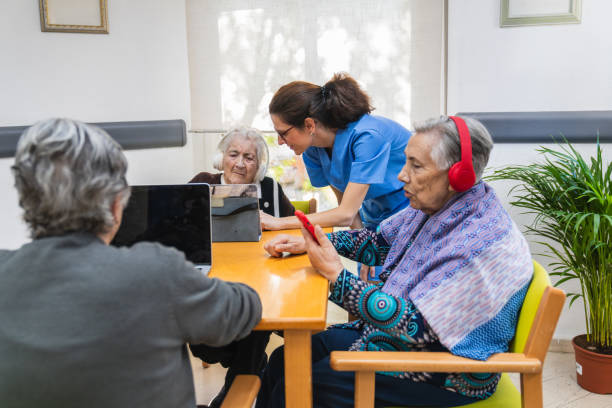 istock Elderly residents engaging with technology in nursing home 2198222206