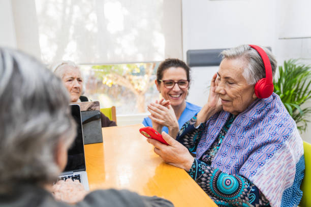 istock Seniors engaging with technology in nursing home 2198222213