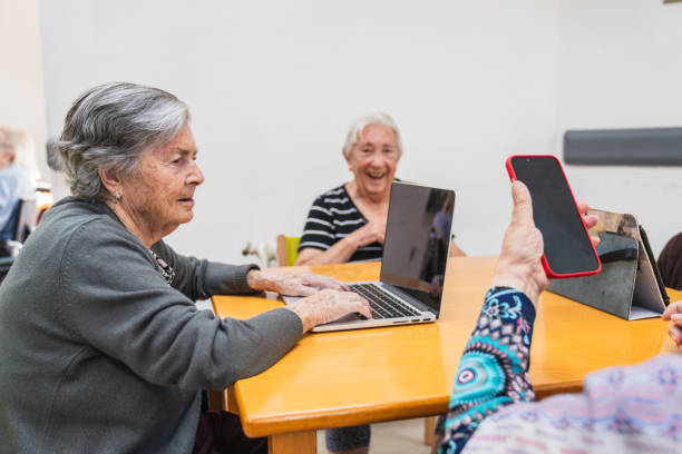 istock Elderly women engaging with technology in nursing home 2198222220