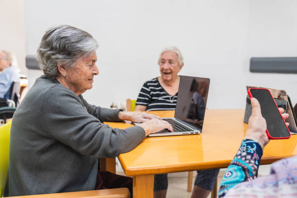 istock Seniors engaging with technology in nursing home 2198222221