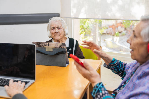 istock Seniors engaging with technology in nursing home 2198222245