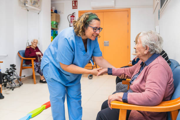 istock Nurse interacting with senior residents in nursing home 2198222345