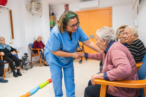 istock Caring nurse assisting seniors in nursing home 2198222347