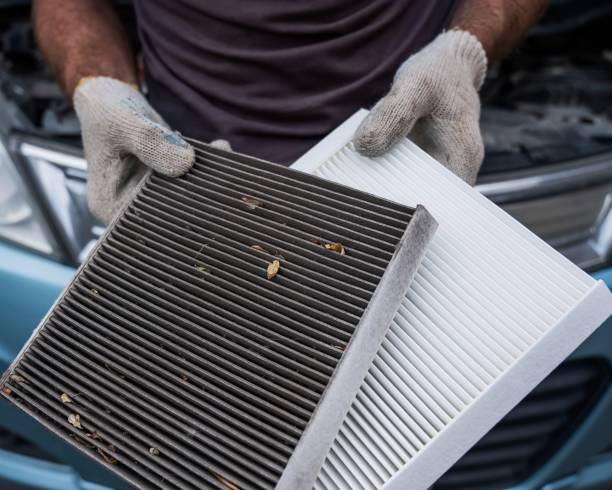 istock The master changes the cabin air filter of the car. 2198223562