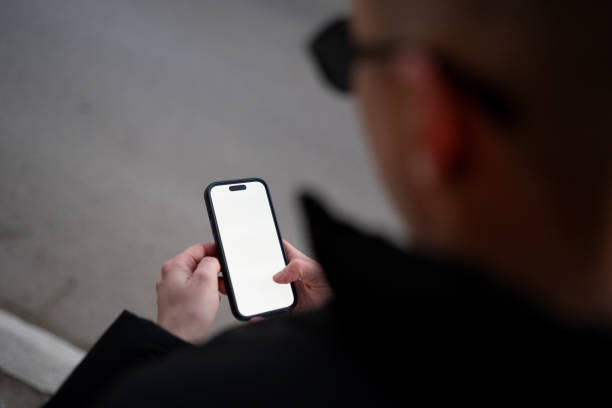 istock a guy is typing a message on a phone in the city 2198224202