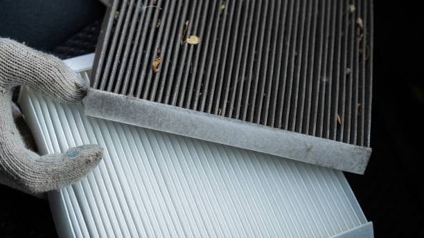 istock The master changes the cabin air filter of the car. 2198224364