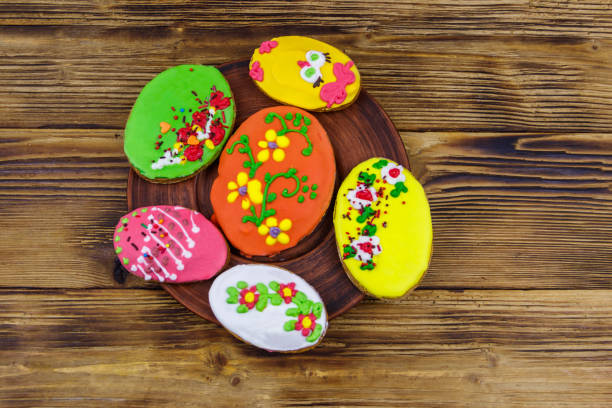 Egg shaped easter gingerbread cookies on wooden table. Top view. Sweets for celebrate Easter