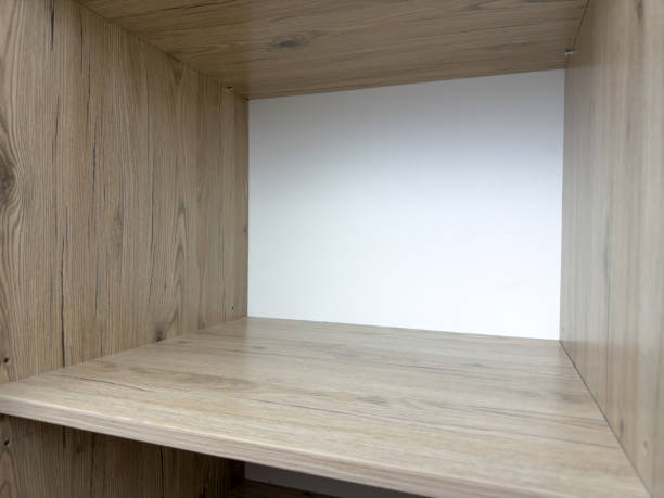 istock Empty shelf inside closet with open door. Filling space with clothes after moving into new home 2198228131