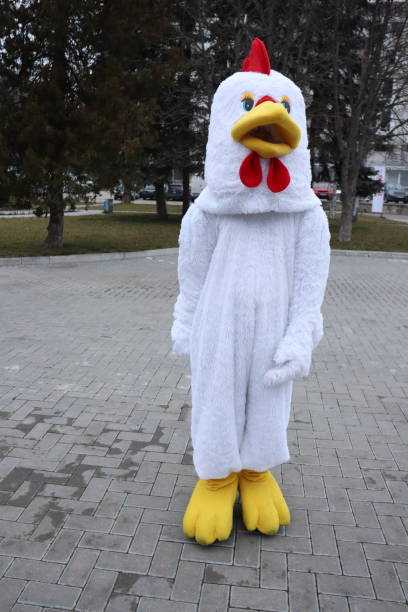istock A Playful Chicken Costume Character Interacting Cheerfully in a Public Gathering Space 2198228276
