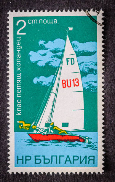Sandwich, Massachusetts, USA February 2, 2025- A  1974 postage stamp printed in  Egypt showing  a racing yacht under sail with a two man crew.