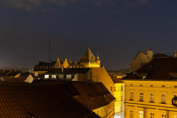 Long exposure technique captures the blurred movement of vehicles and electric trams. Creating striking red and orange light trails against the serene blue twilight sky over a historic european city