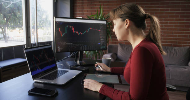 istock Businesswoman working in the office on stock market exchange data using TradingView 2198245111