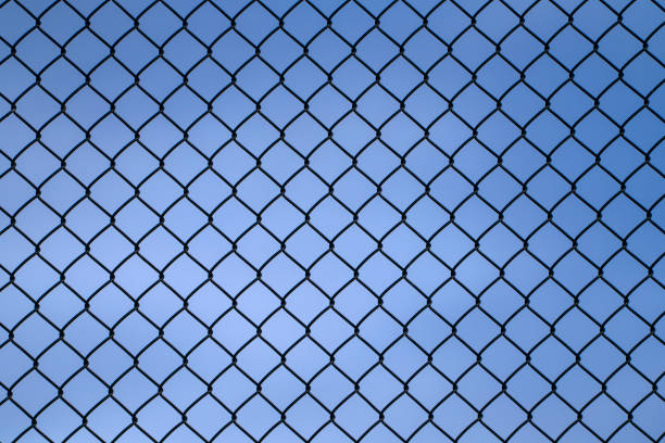 close up on iron chainlink fence against sky