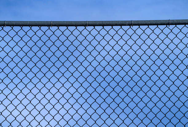 istock close up on iron chainlink fence against sky 2198249033