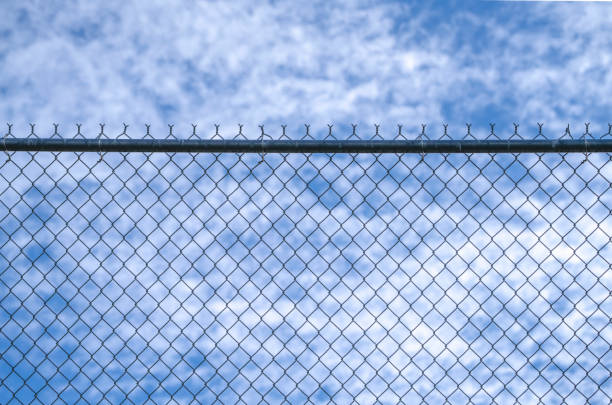 close up on iron chainlink fence against sky