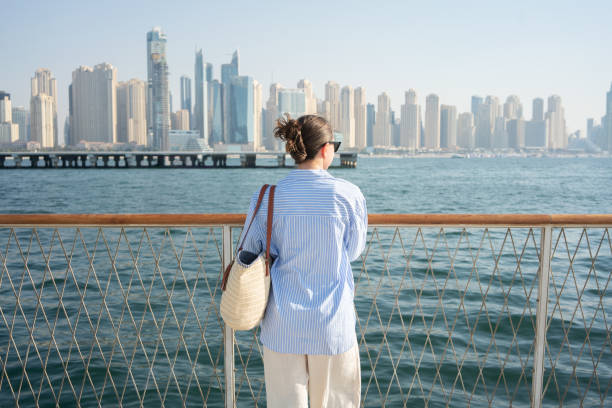 istock Woman looking at the Dubai waterfront cityscape 2198249284