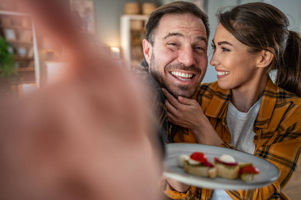 istock Happy couple posing for a selfie with their bruschettas 2198250781