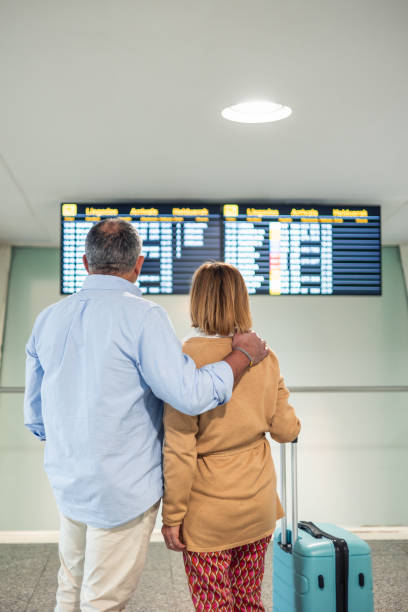 istock Senior Couple Checking Flight Information at Airport 2198250902