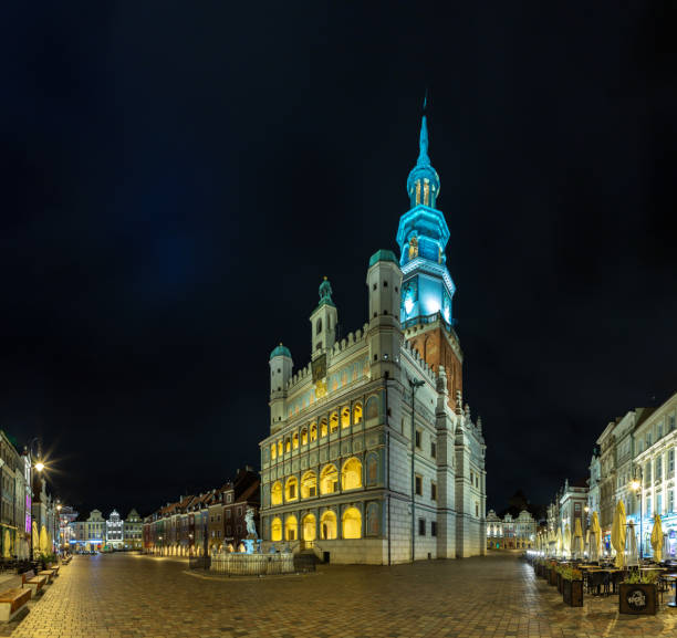 A picture of the Poznan Old Market Square at night, with the Town Hall on display.
