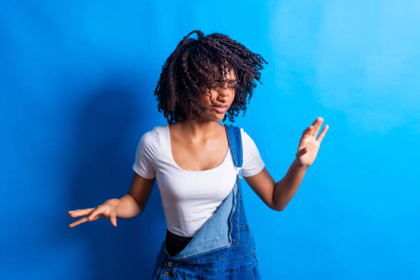 istock Young woman dancing with passion and energy on blue background 2198253751