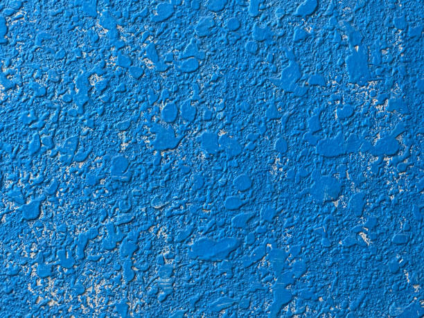 istock Vivid Dodgerblue Painted Onto a Cratered Stucco Wall With White Base Color 2198254128