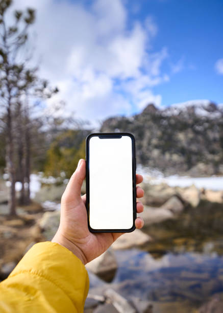 istock Hiker holding smartphone with blank screen in mountain landscape 2198255535