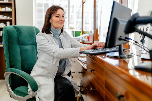 Pharmacist working on a computer in a well-organized pharmacy interior