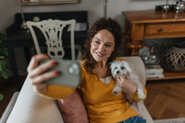 istock Woman Taking a Selfie with Her Cute Dog 2198270479