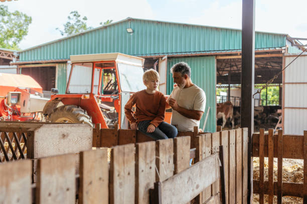 istock Father and Son Bonding on Rustic Farm 2198272598