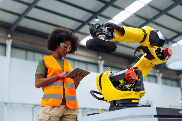 istock Engineer Monitoring Robotic Arm in Factory Setting 2198272632