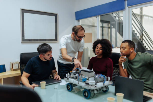 istock Robotics engineers analyzing a prototype in the office meeting room 2198272636