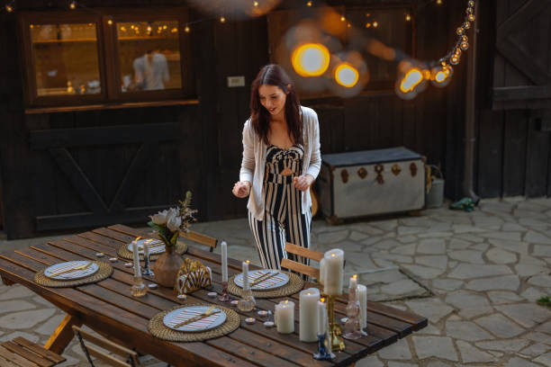 istock Young Woman Arranging Outdoor Dinner Setting 2198272691